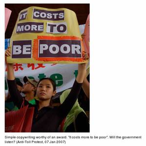 it cost moor to be poor protest banner